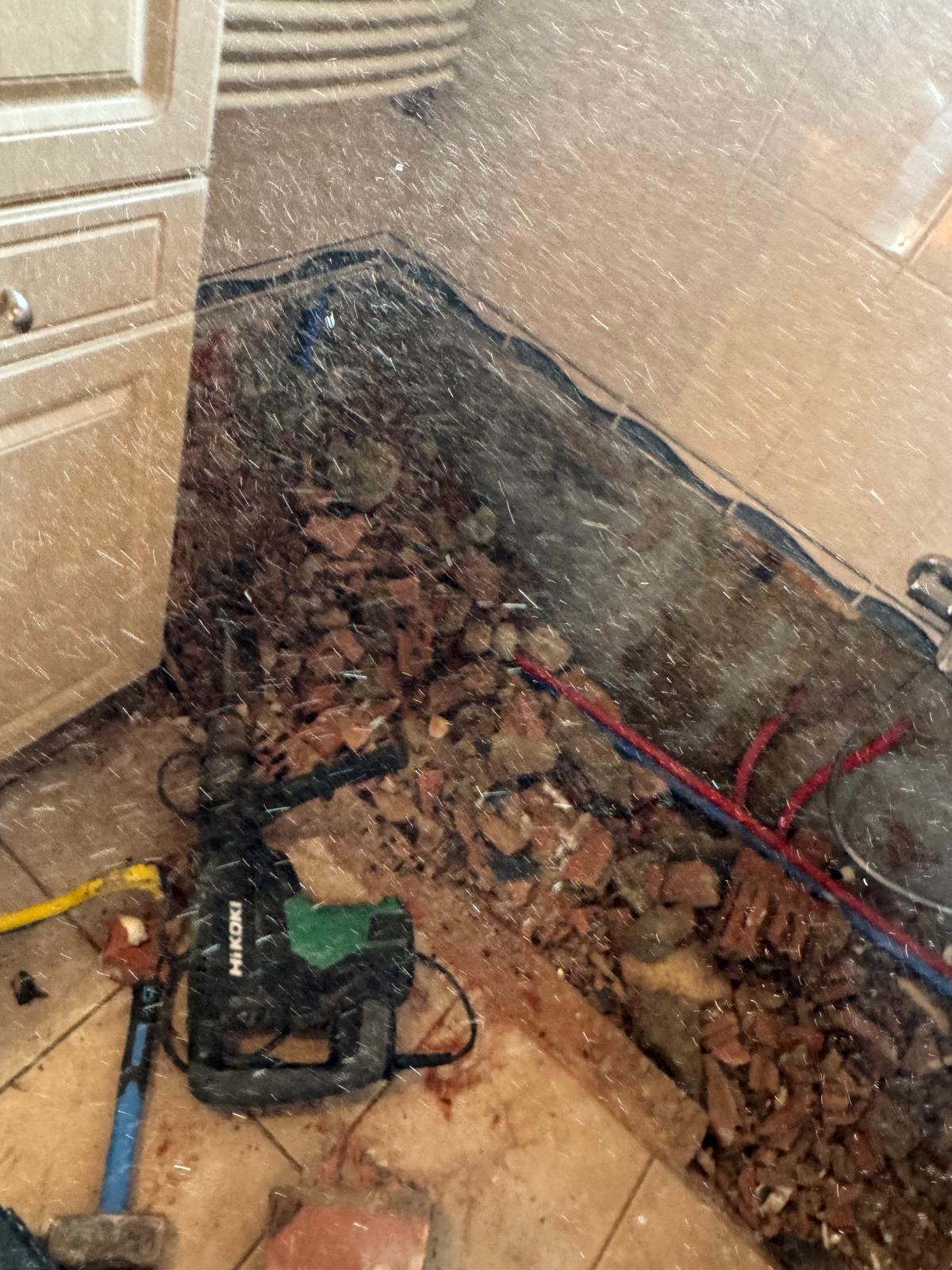 Stof en puin op de badkamer vloer tijdens renovatie met bouwgereedschap