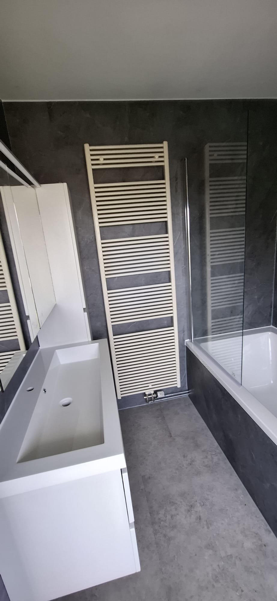 Moderne badkamer met witte badkuip en betegelde muren